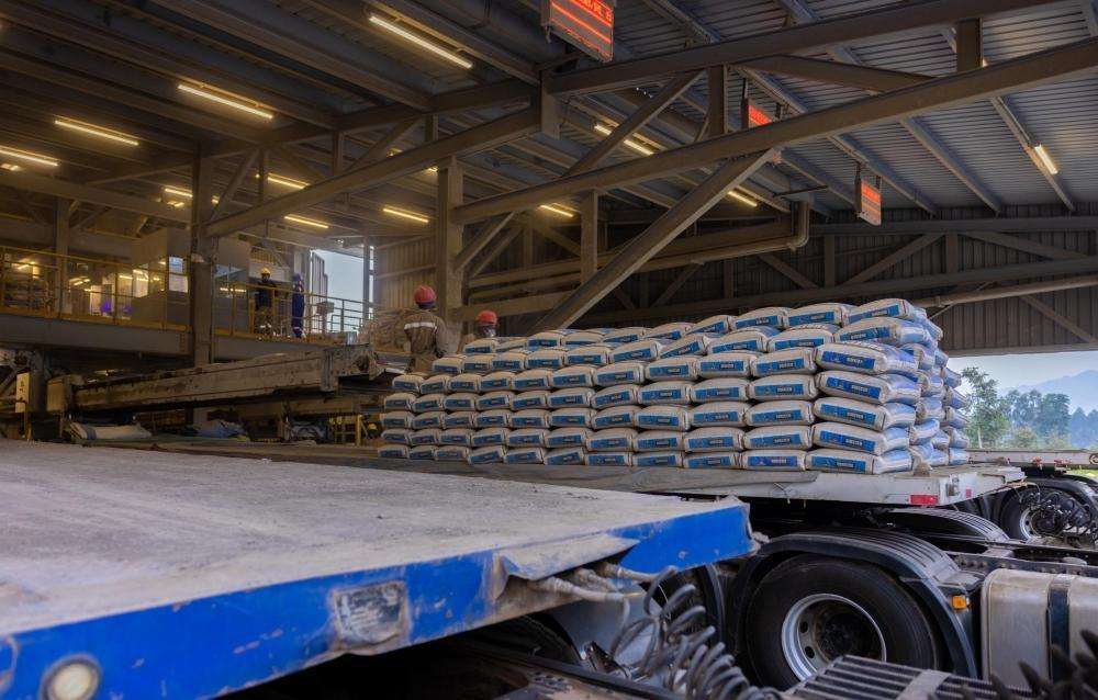 Cement bags being loaded onto a truck at an industrial dispatch facility Cement bags being loaded onto a truck at an industrial dispatch facility